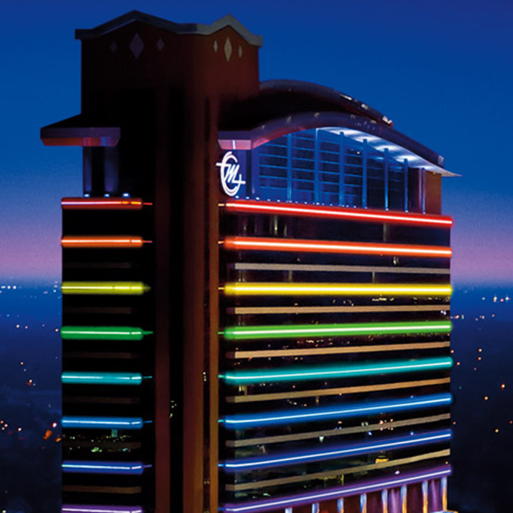 Aerial view of the casino lit up with color in the evening